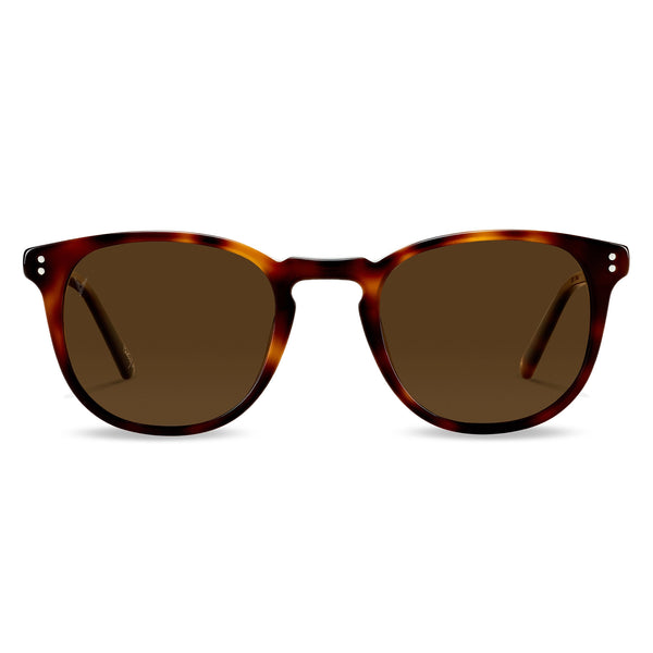 A pair of round full frame sunglasses with a patterned frame and tinted lenses.