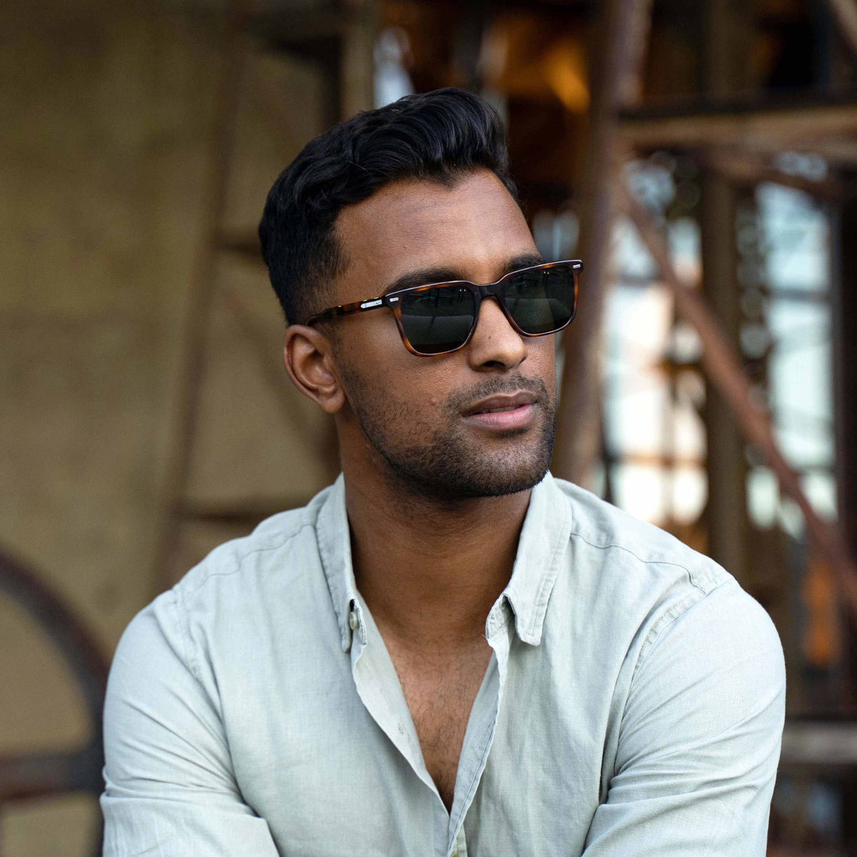 Man wearing sunglasses with a blurred background