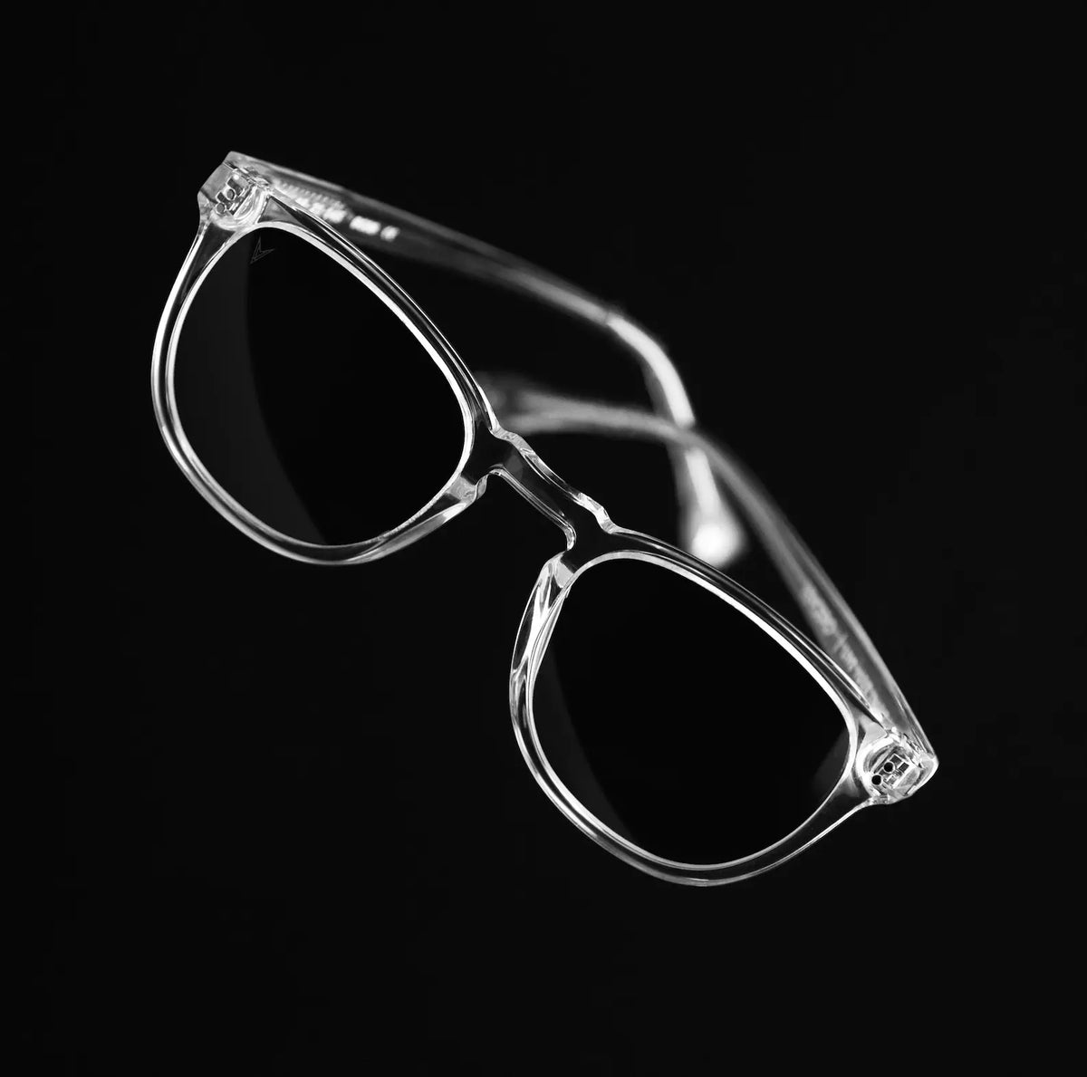 Clear sunglasses with black lenses on a black background