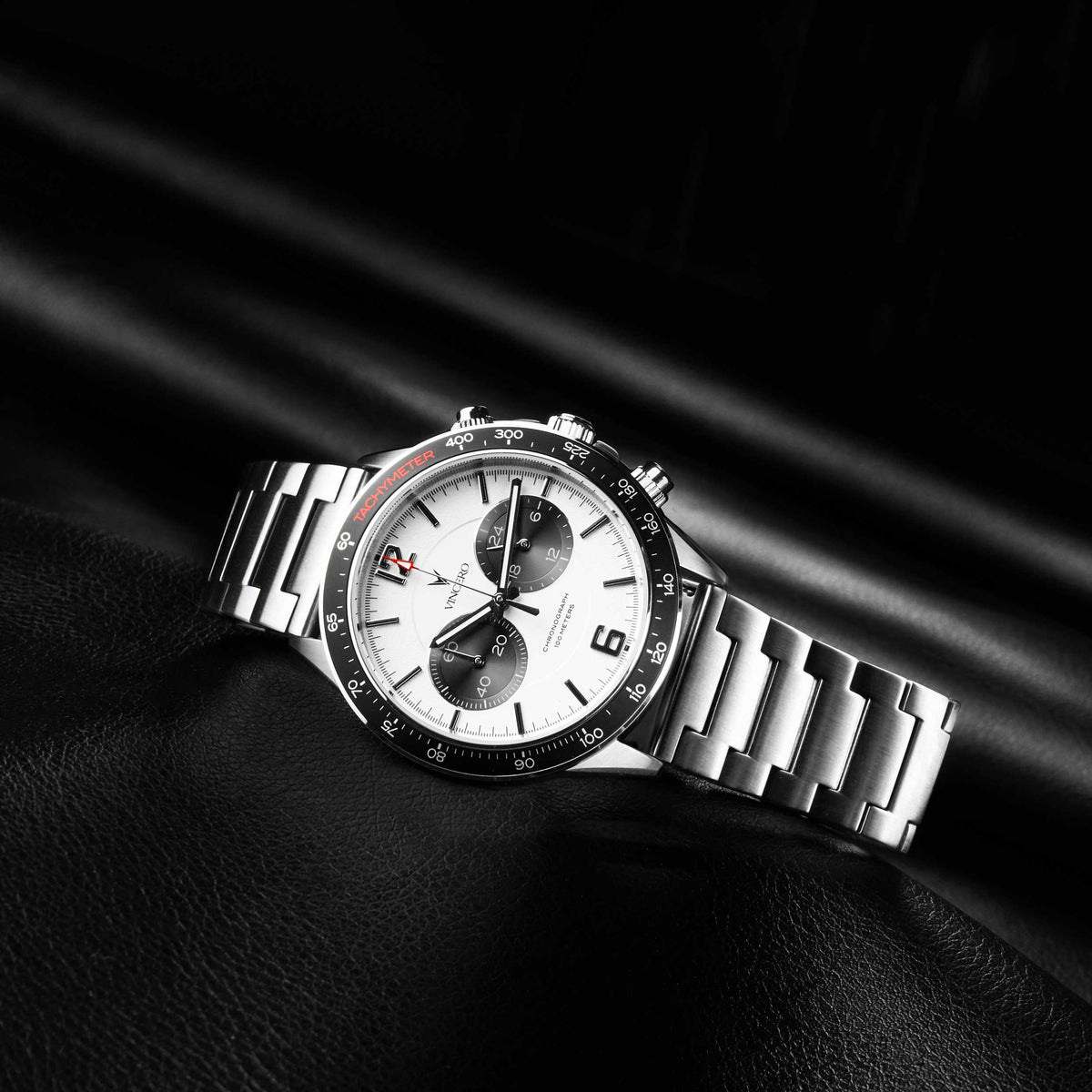 Silver wristwatch with a detailed face on a black background