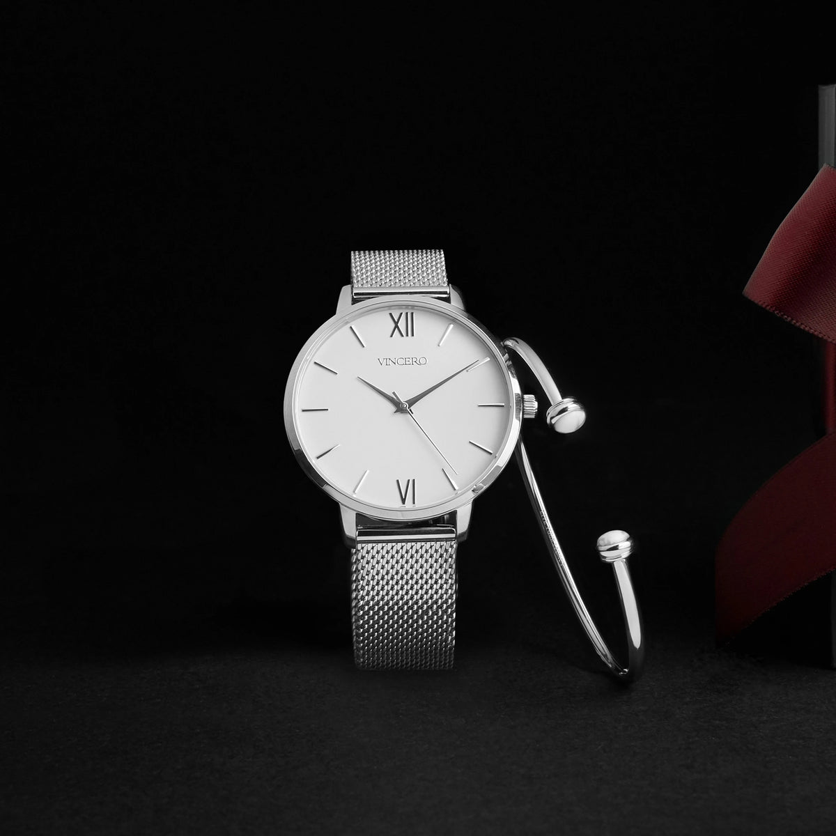 Silver watch and bracelet set on a black background