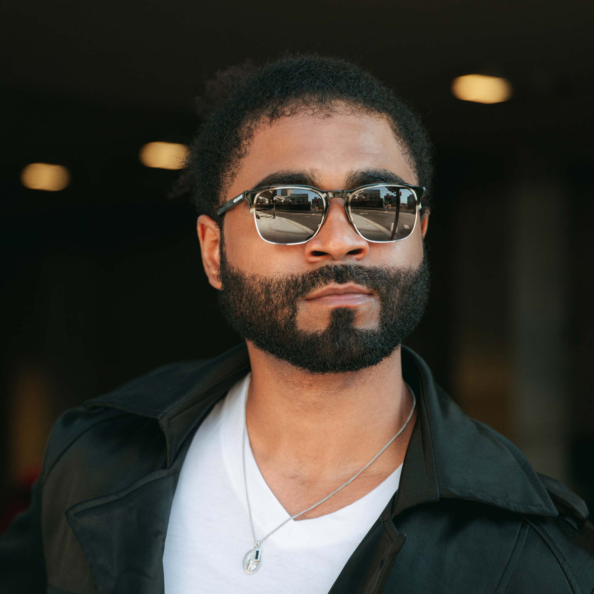 Man wearing sunglasses with a blurred background