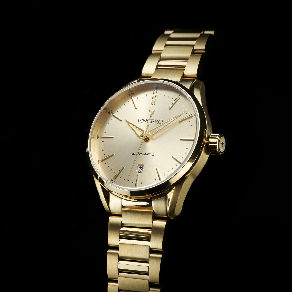 Gold wristwatch with a visible brand name on a black background