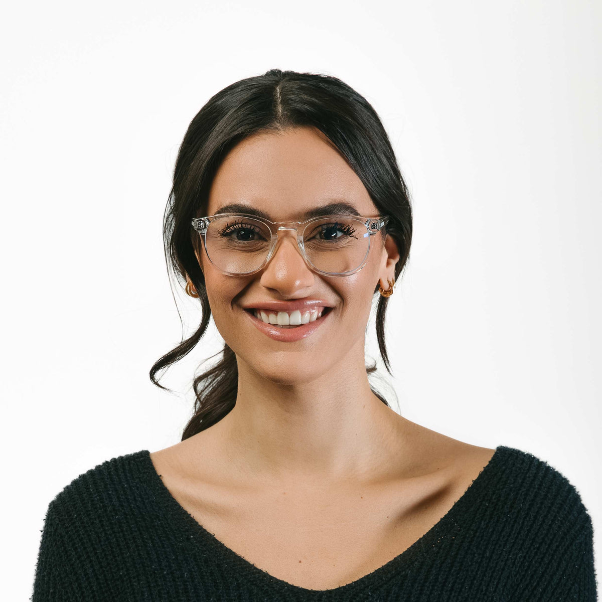 Woman wearing glasses and a black sweater on a white background