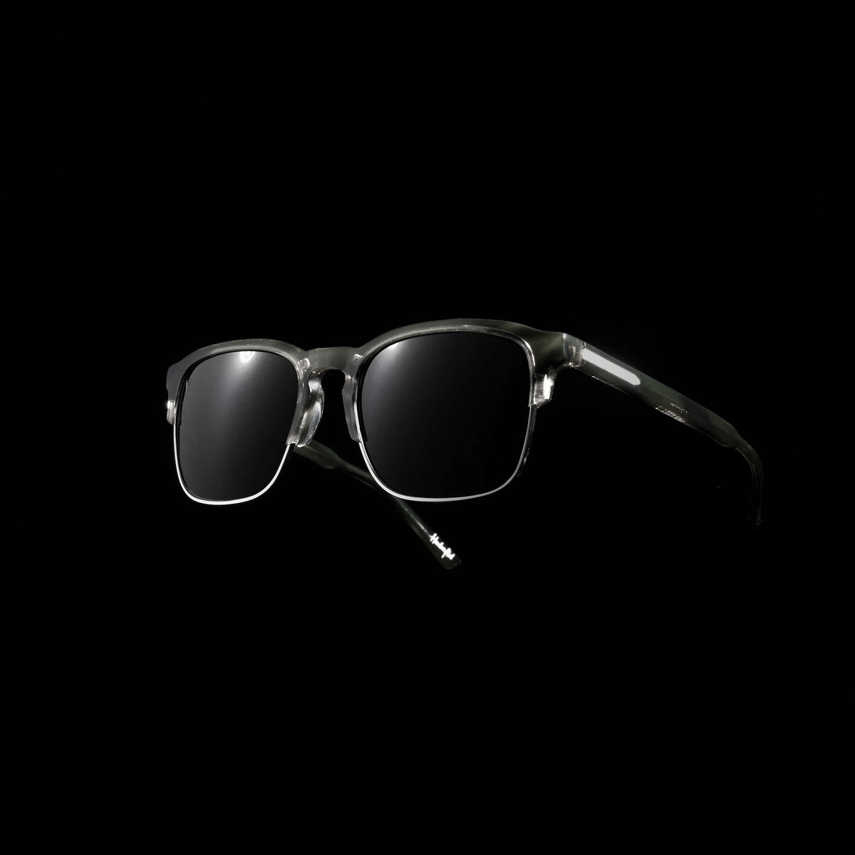 Sunglasses with dark lenses on a black background