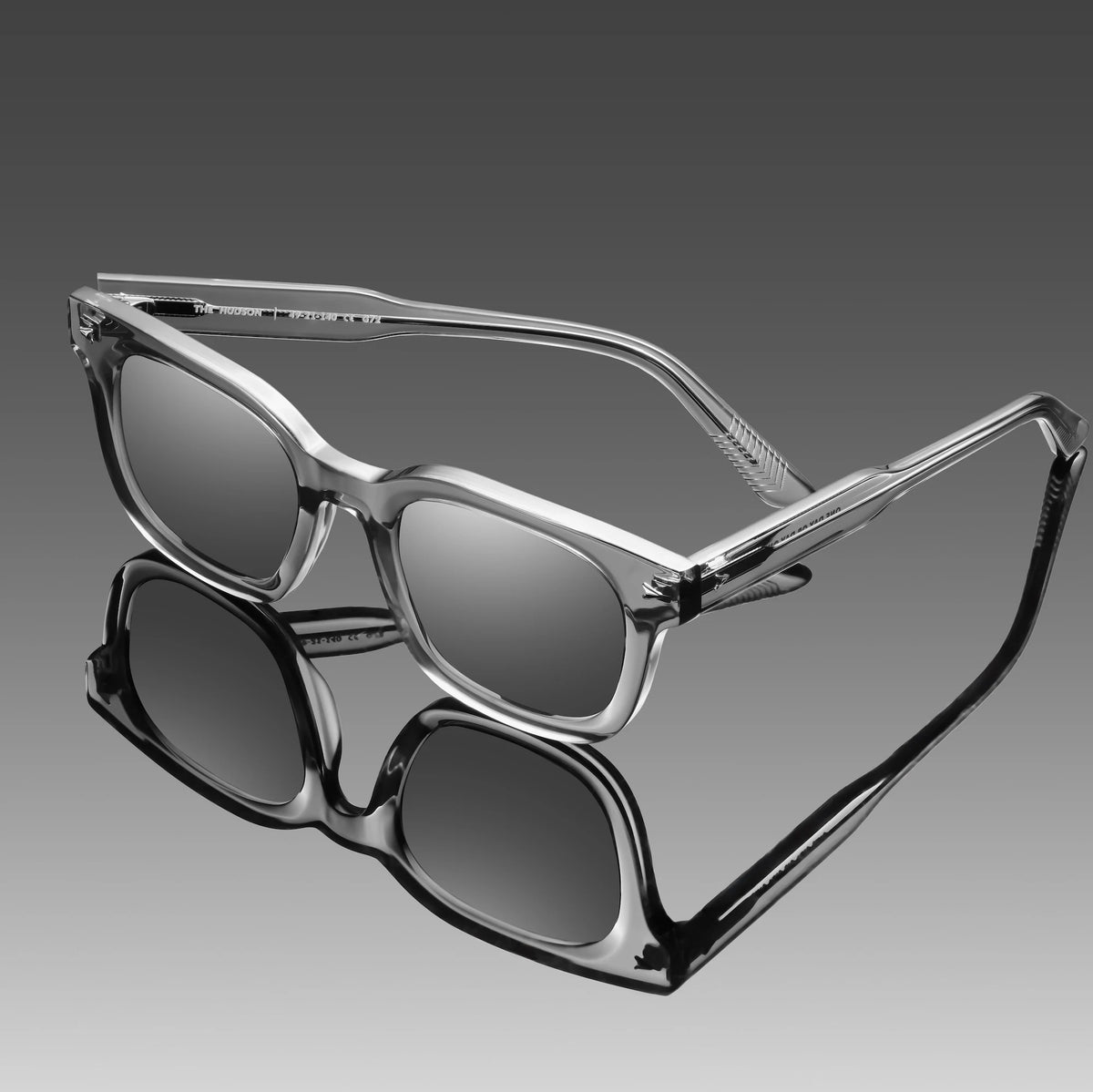 Sunglasses with a reflective surface on a gradient gray background