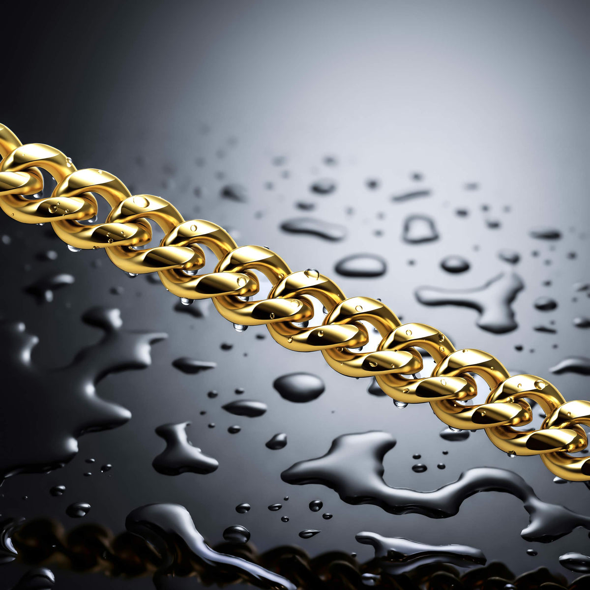 A close-up of a shiny gold chain draped diagonally across a glossy dark surface with water droplets, against a gray gradient background.