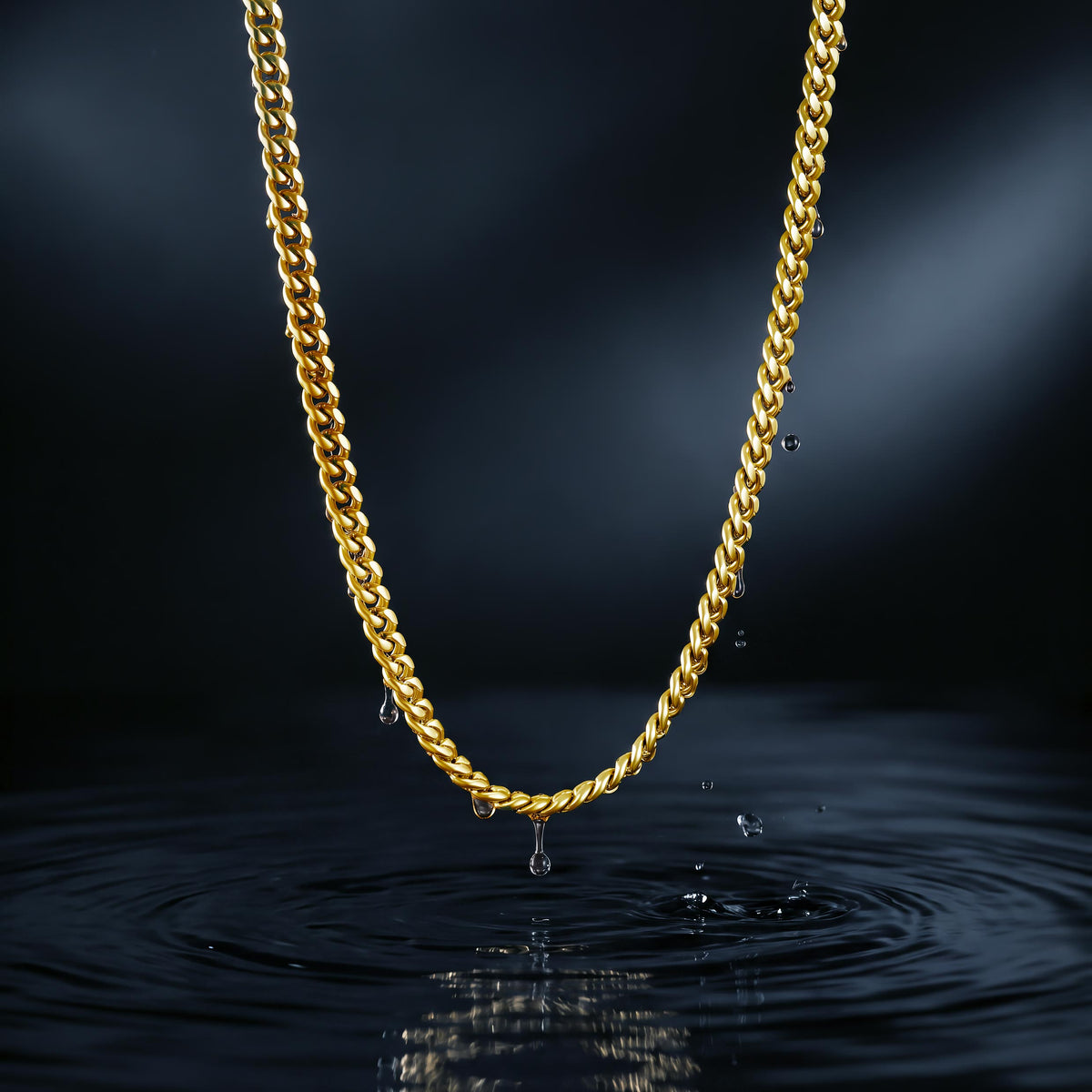 Mens gold cuban chain necklace over water