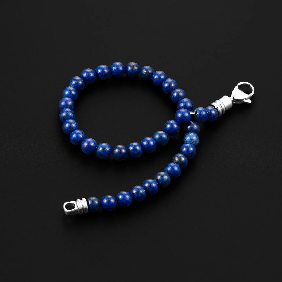 Blue beaded keychain with silver clasp on a black background