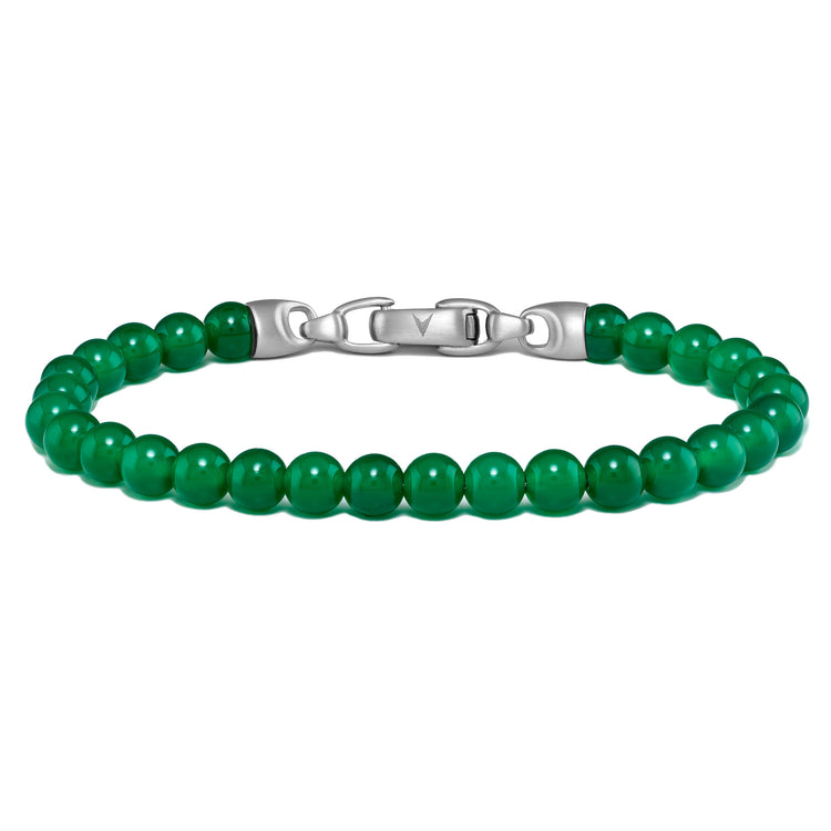 Green beaded bracelet with silver clasp on a white background