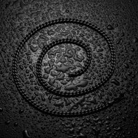 Close-up of a textured surface with water droplets and circular patterns.