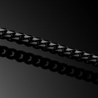 Close-up of a black chain on a dark background
