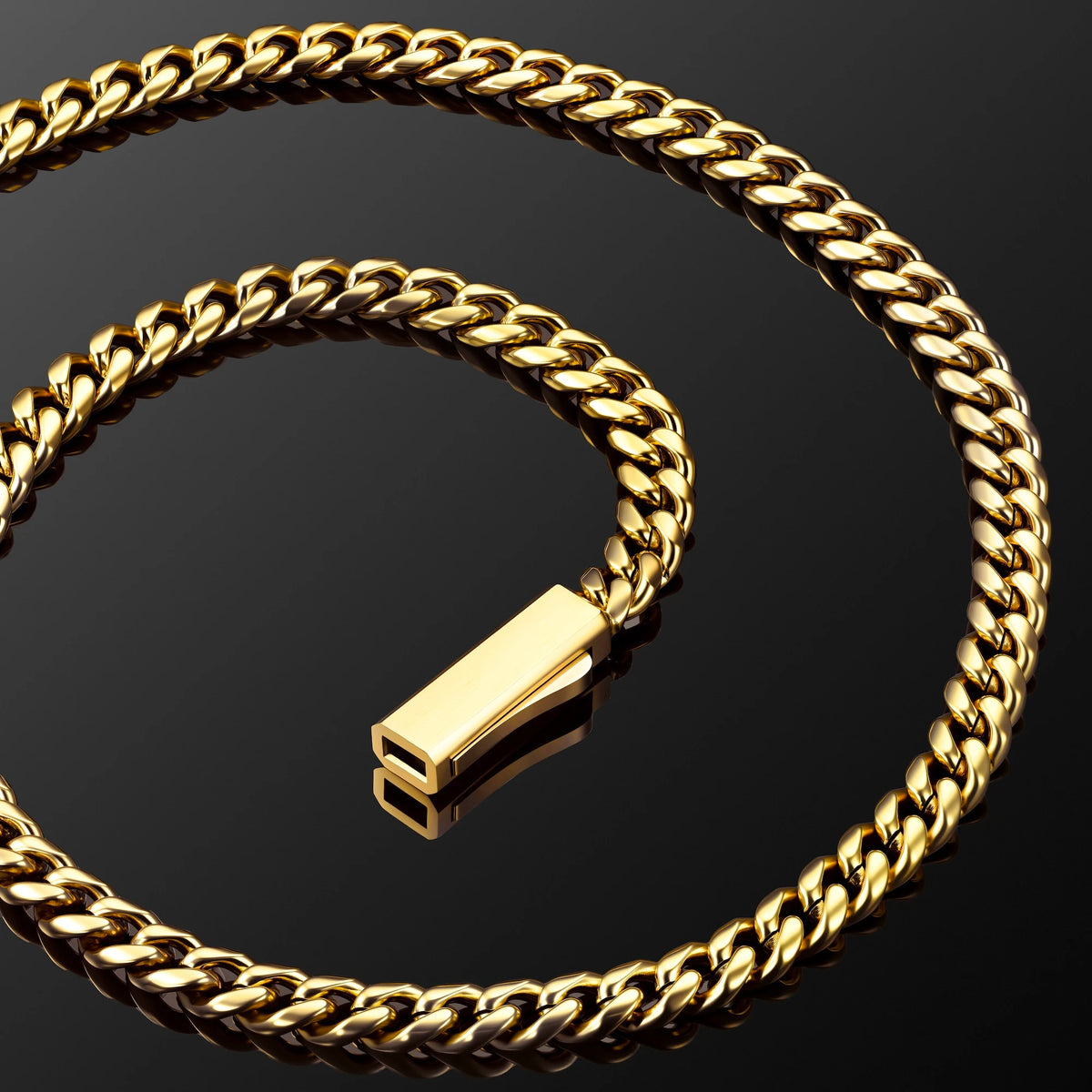 A gold Cuban link chain necklace with a polished rectangular clasp, arranged in a spiral on a reflective black surface.