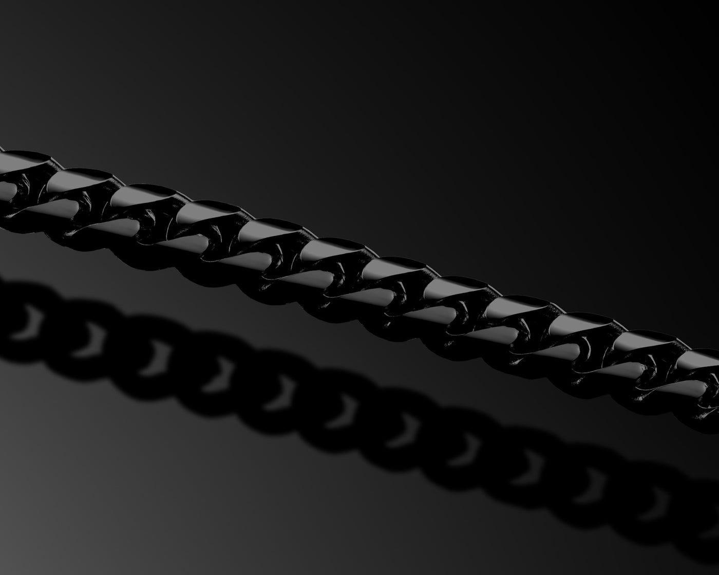 Close-up of a black metal chain on a dark background