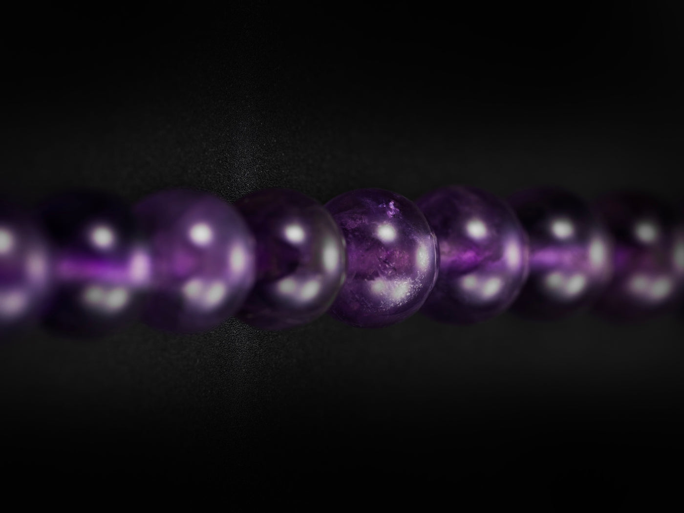 Close-up of purple beads on a dark background