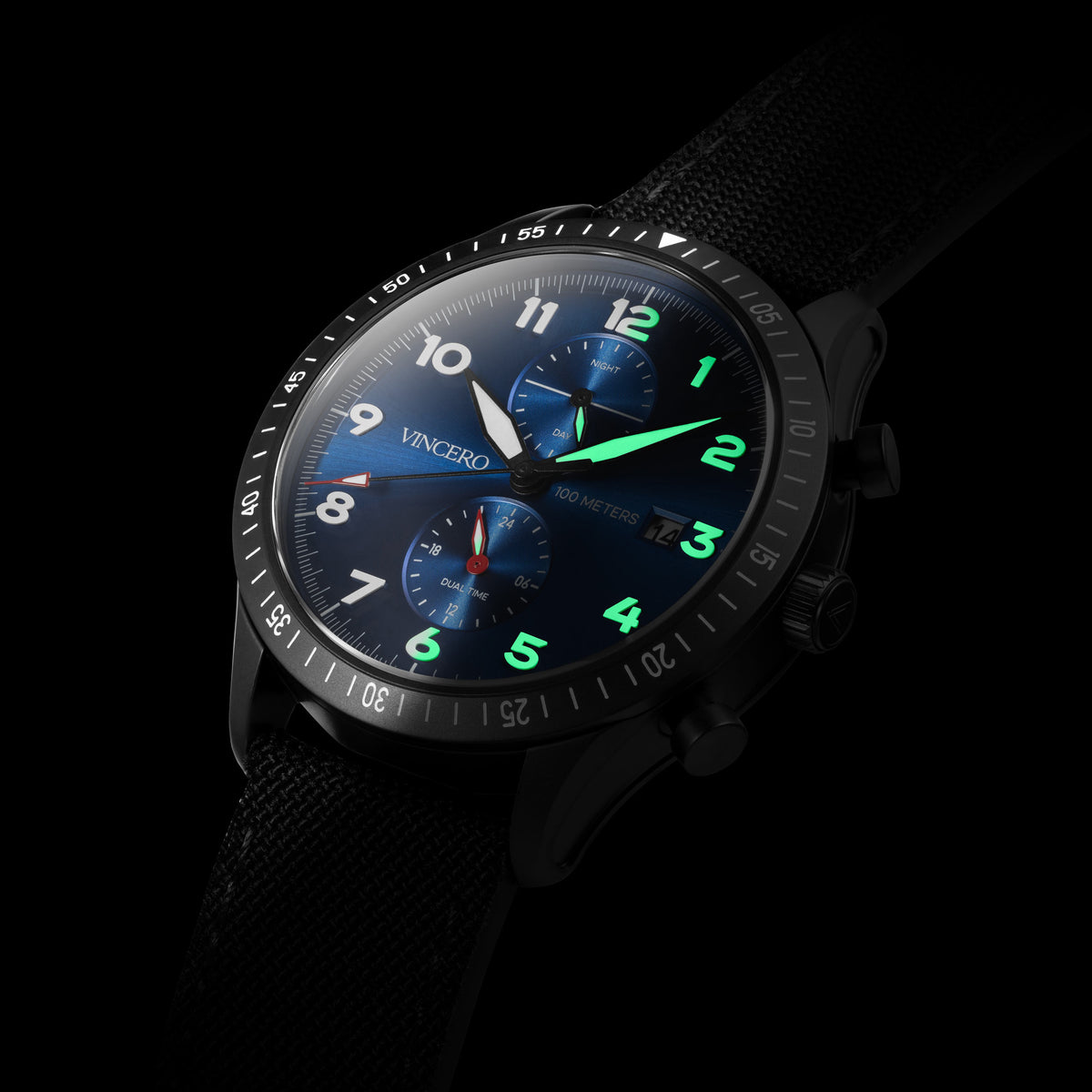 Wristwatch with dark face and green accents on a black background