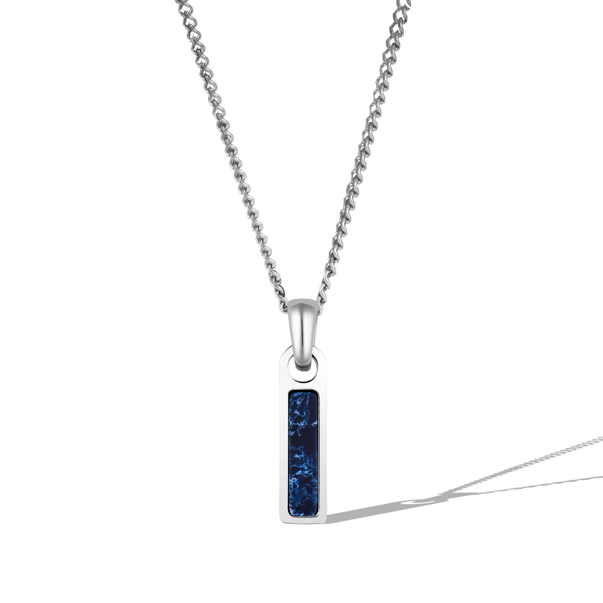 A silver necklace with a rectangular red tag pendant attached to a chain.