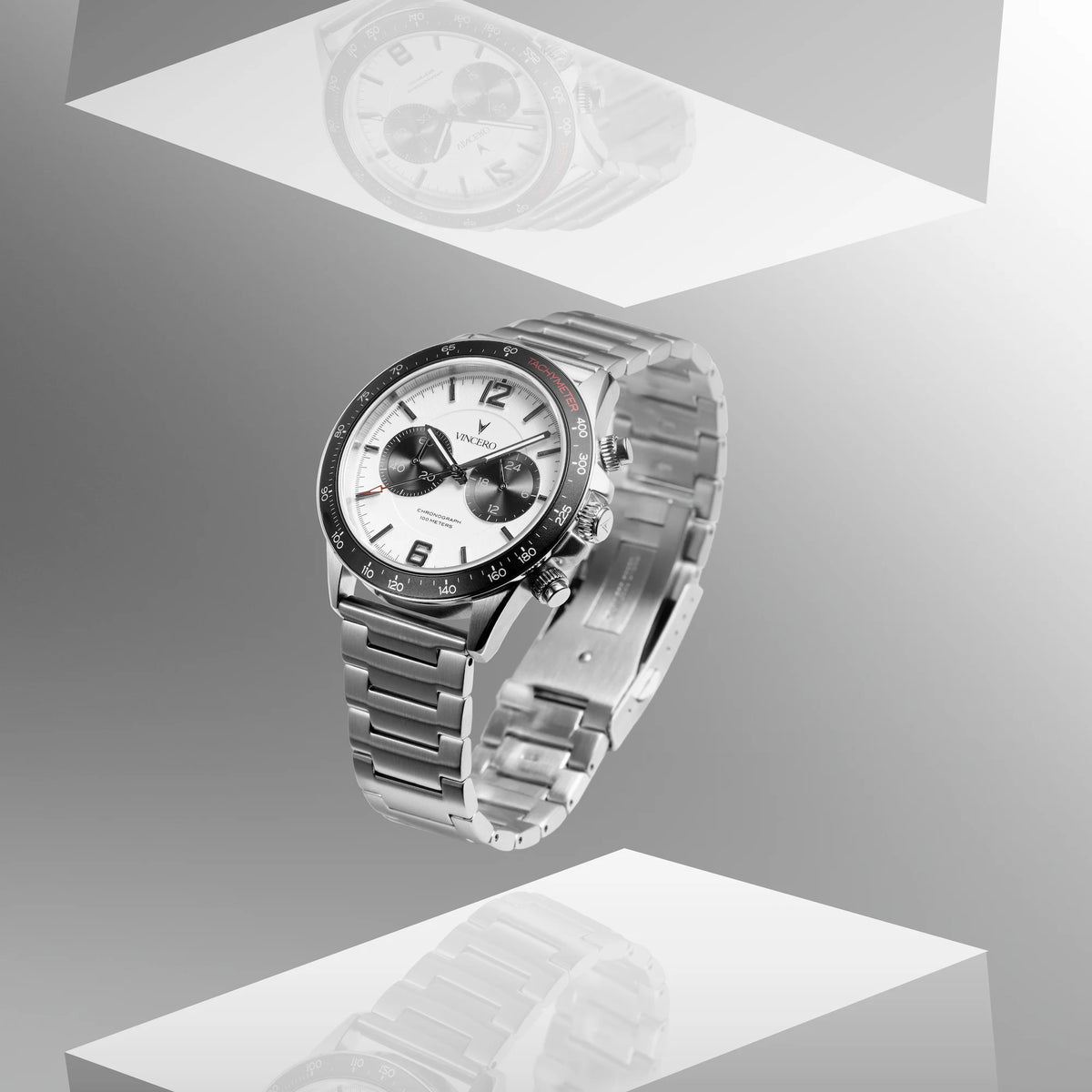 Silver watch with a detailed face on a gray background