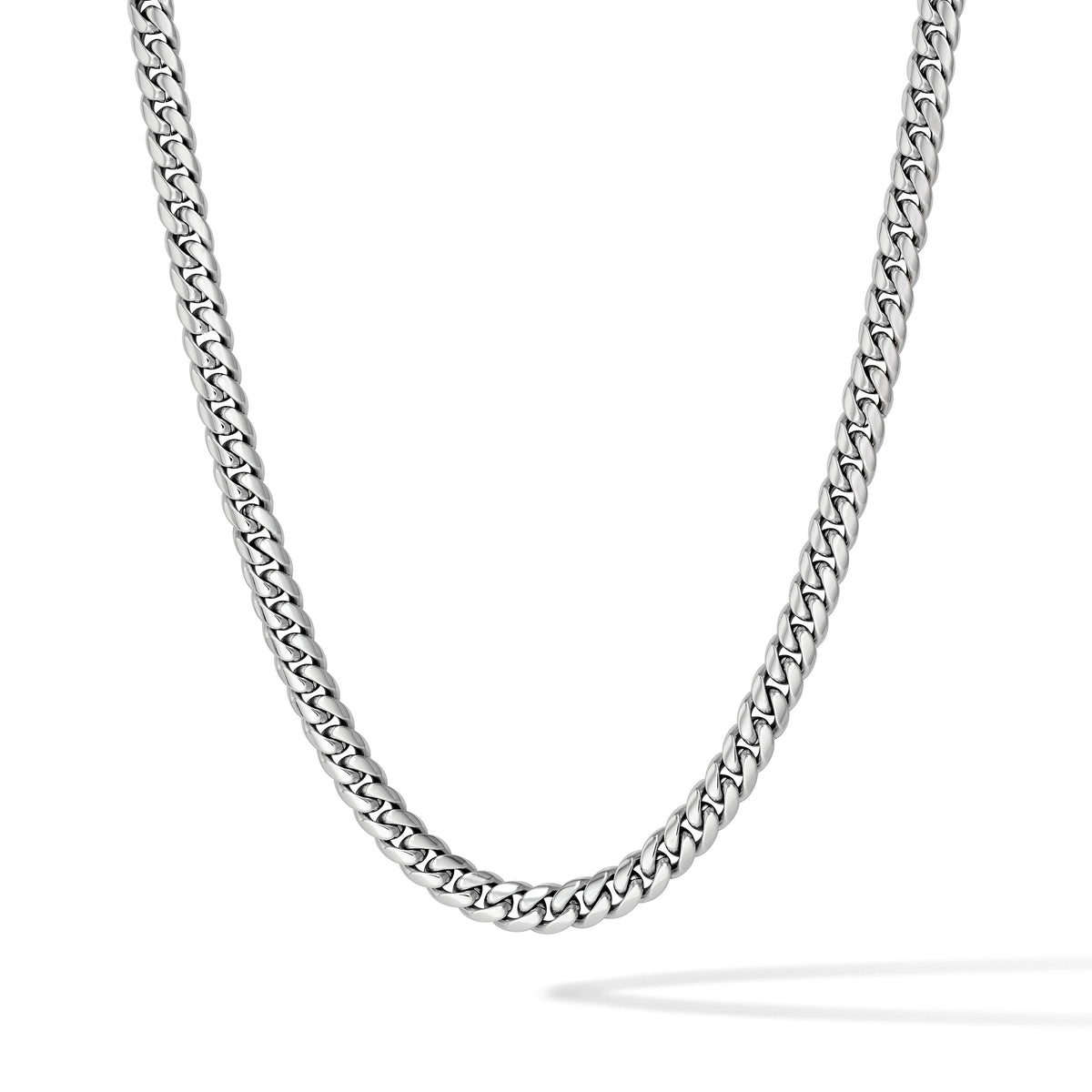 A silver-toned metal chain necklace with a curb link pattern, shown draped in a U-shape against a clean white background.