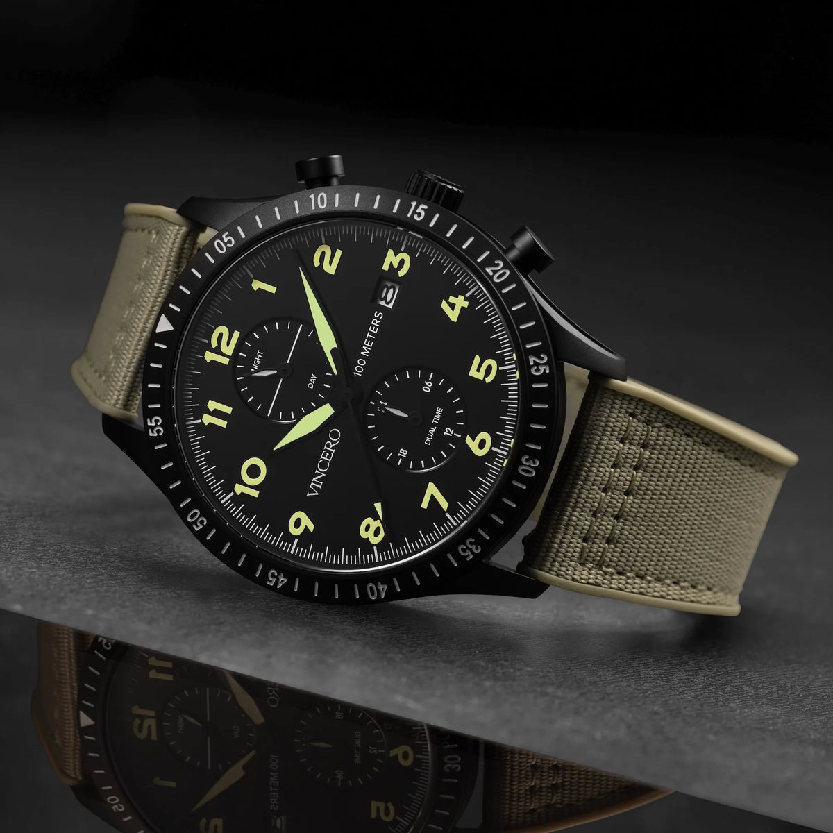 Watch with a green face and beige strap on a dark background