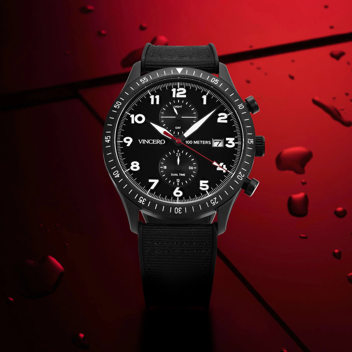 Black wristwatch with detailed face on a red textured background