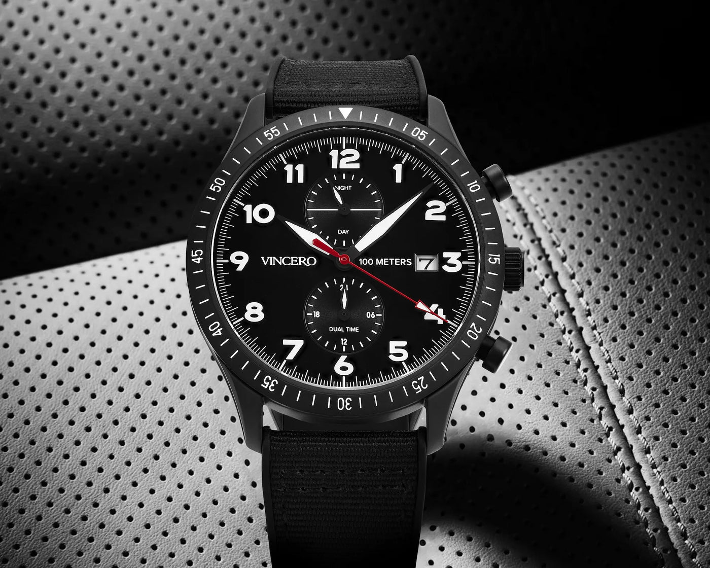 Black wristwatch with detailed face on a textured background