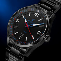 A close-up of a VINCERO A-250 men's watch featuring a black stainless steel case and bracelet, a black dial with white Arabic numerals, and blue and red hands.