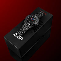 A black analog watch with a metal link bracelet and black dial sits on top of a black branded box against a dark red gradient background. The box shows the brand name 'Z250' in white.