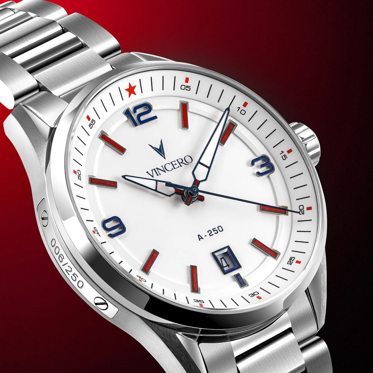 A close-up studio shot of a Vincero A-250 stainless steel wristwatch with a white dial, featuring blue and red accents on the bezel and face, set against a dark red gradient background.