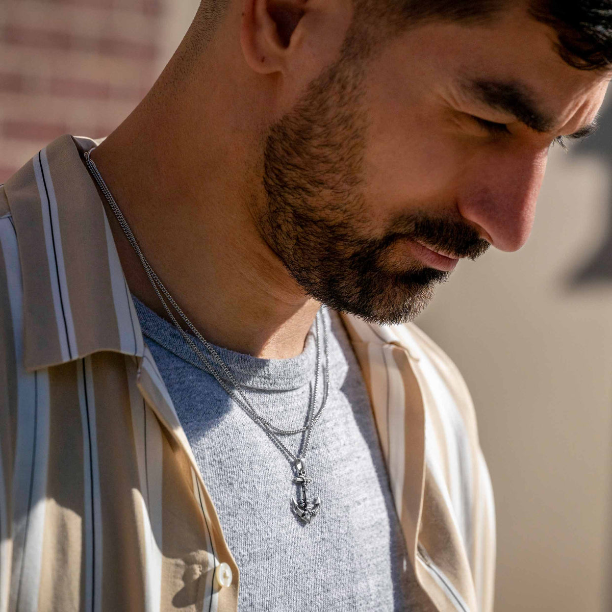 Man wearing a necklace with a blurred background