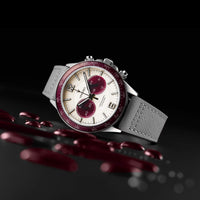 Watch with a gray strap and red accents on a dark background