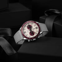 Luxury watch with red and silver design on a dark background