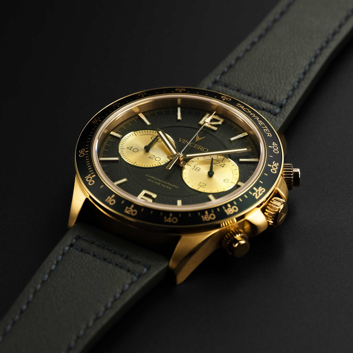 Luxury watch with black and gold face on a dark background