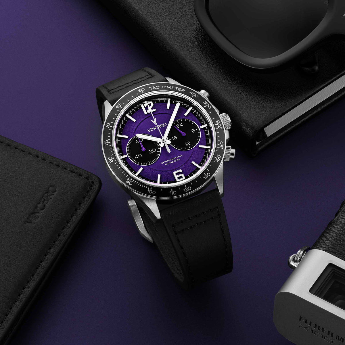 Apex Limited Edition Ultraviolet watch, featuring a violet face, black and silver casing, and black band, displayed with EDC items.