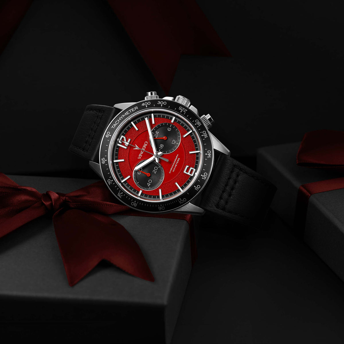 Apex Limited Edition watch, featuring a red face, black and silver casing, and black band, displayed on its side.