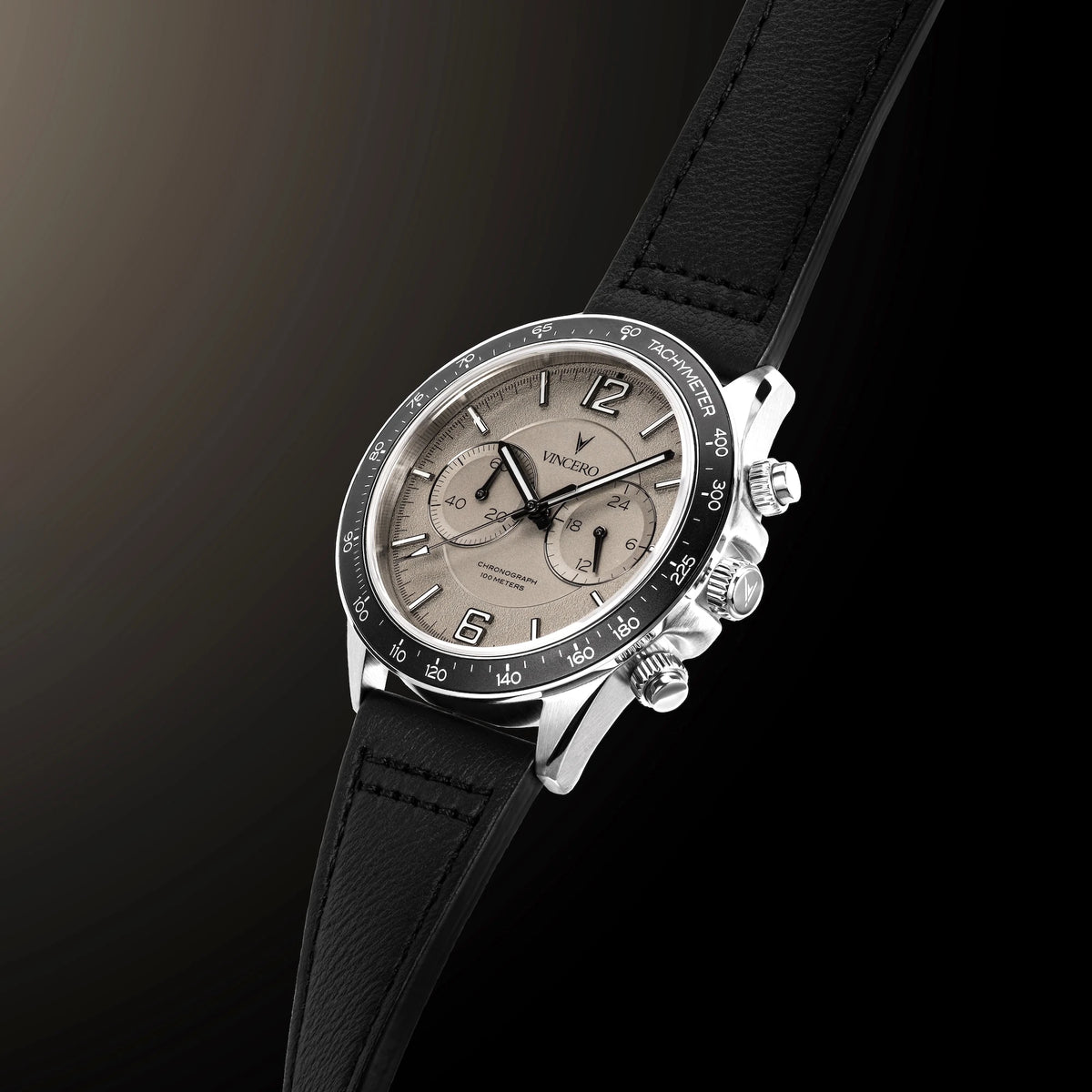 Luxury watch with black leather strap and silver case on a dark background