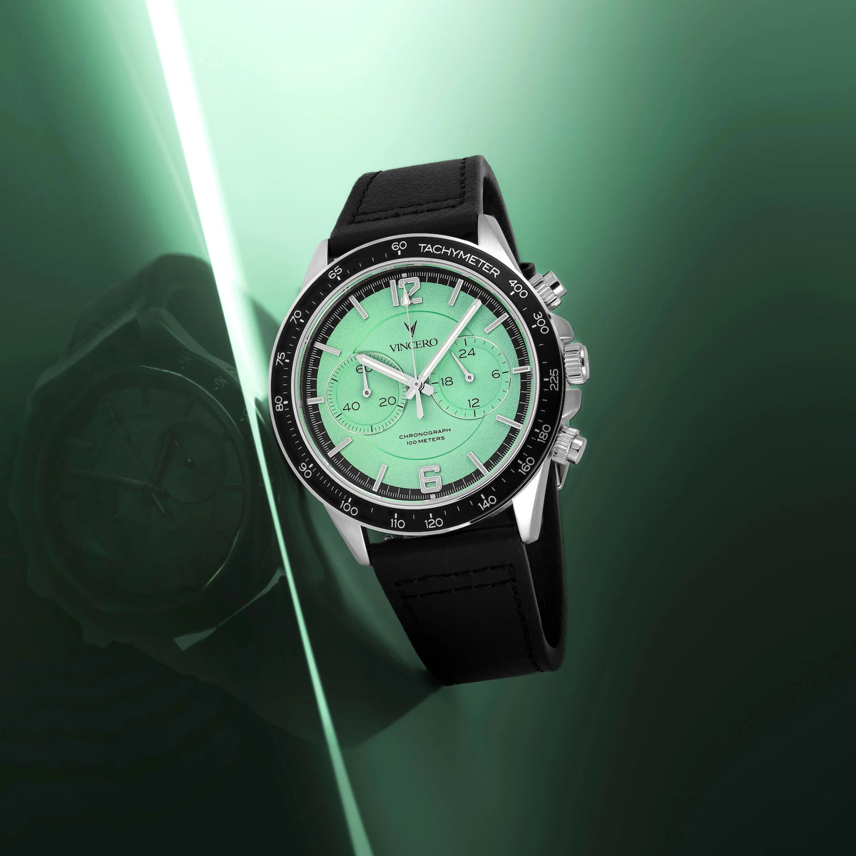Luxury watch with a green face and black strap on a green background