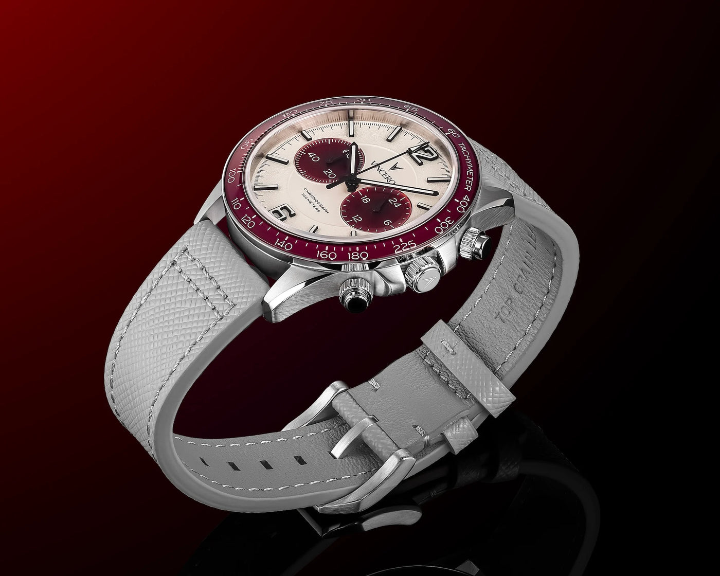 Watch with gray strap and red accents on a dark background