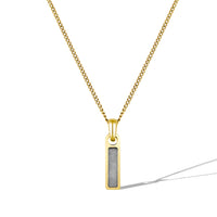 Gold necklace with a rectangular pendant on a white background