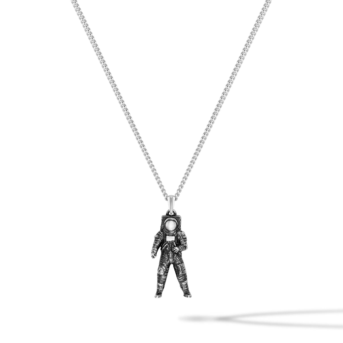 Astronaut pendant on a chain against a white background