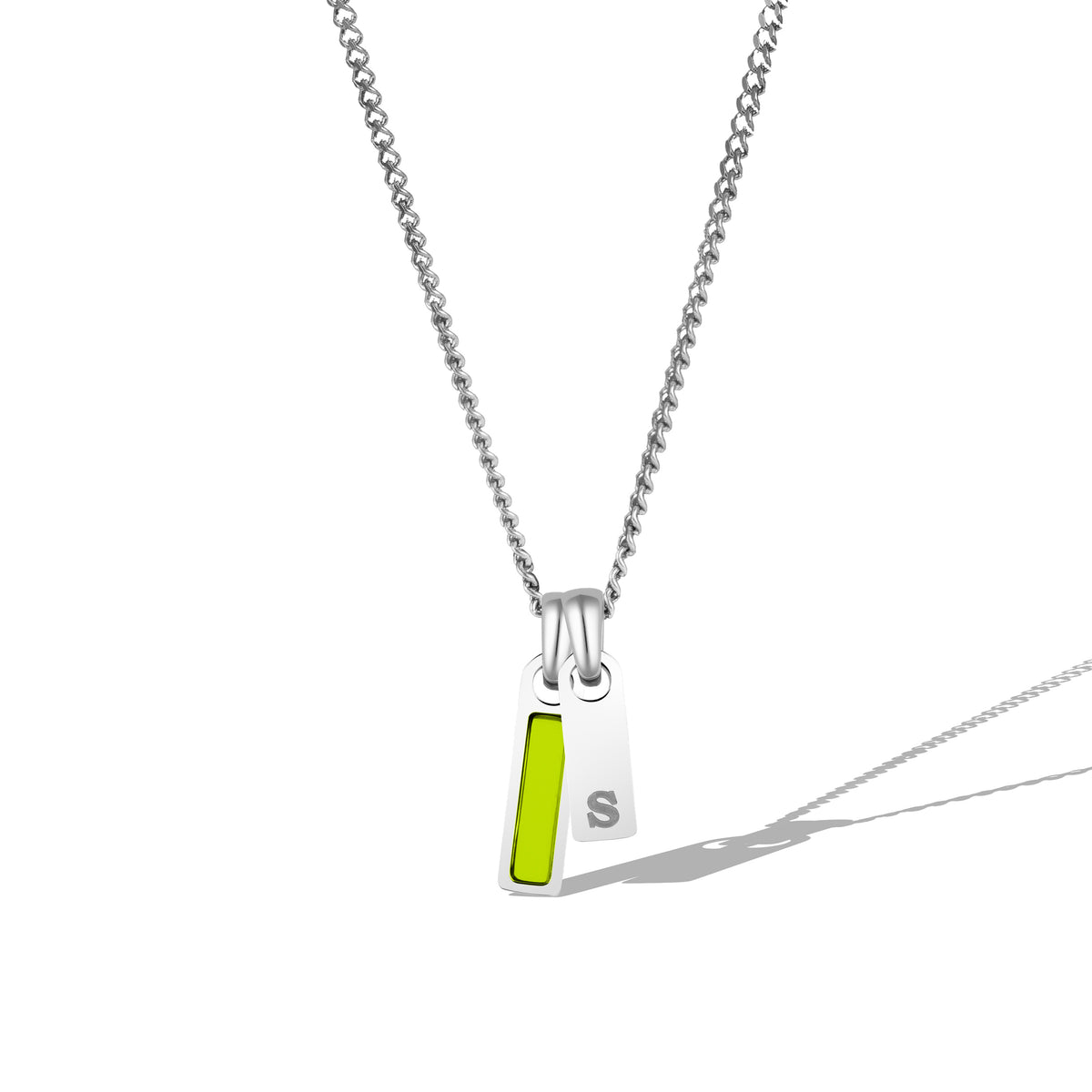 A silver necklace with a rectangular tag pendant featuring a birthstone and a chain link.