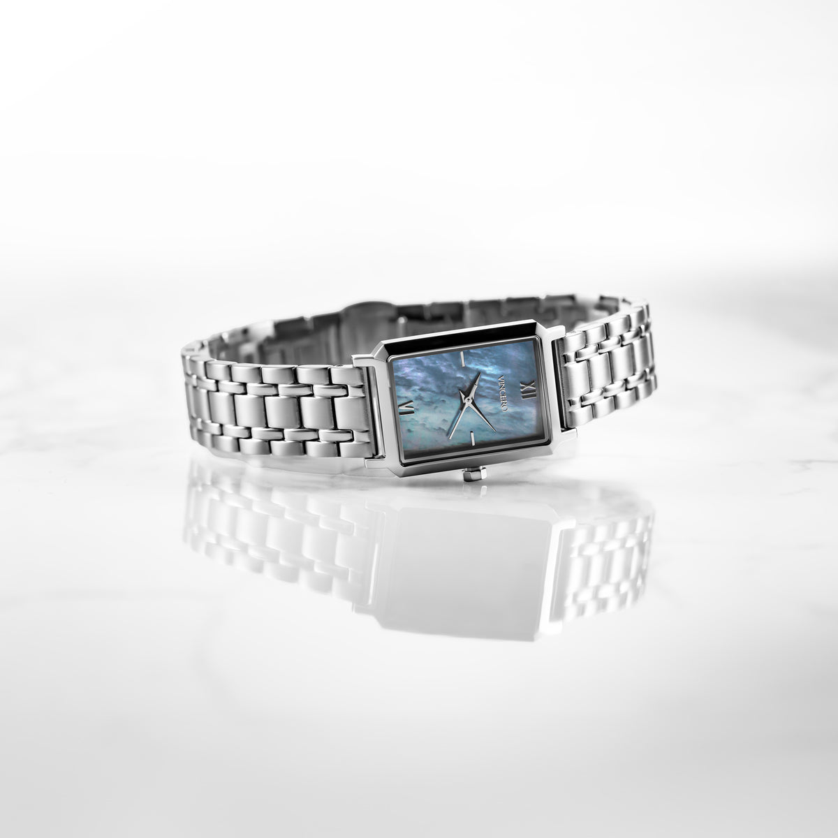 Silver watch with a rectangular face on a white background