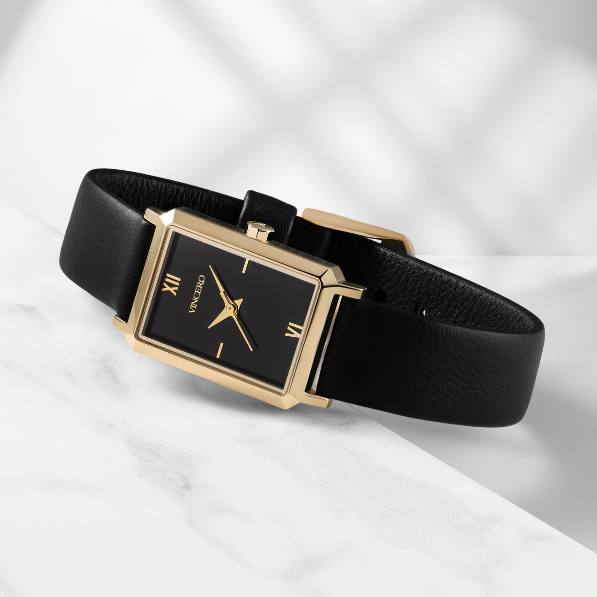 Black watch with gold accents on a white background