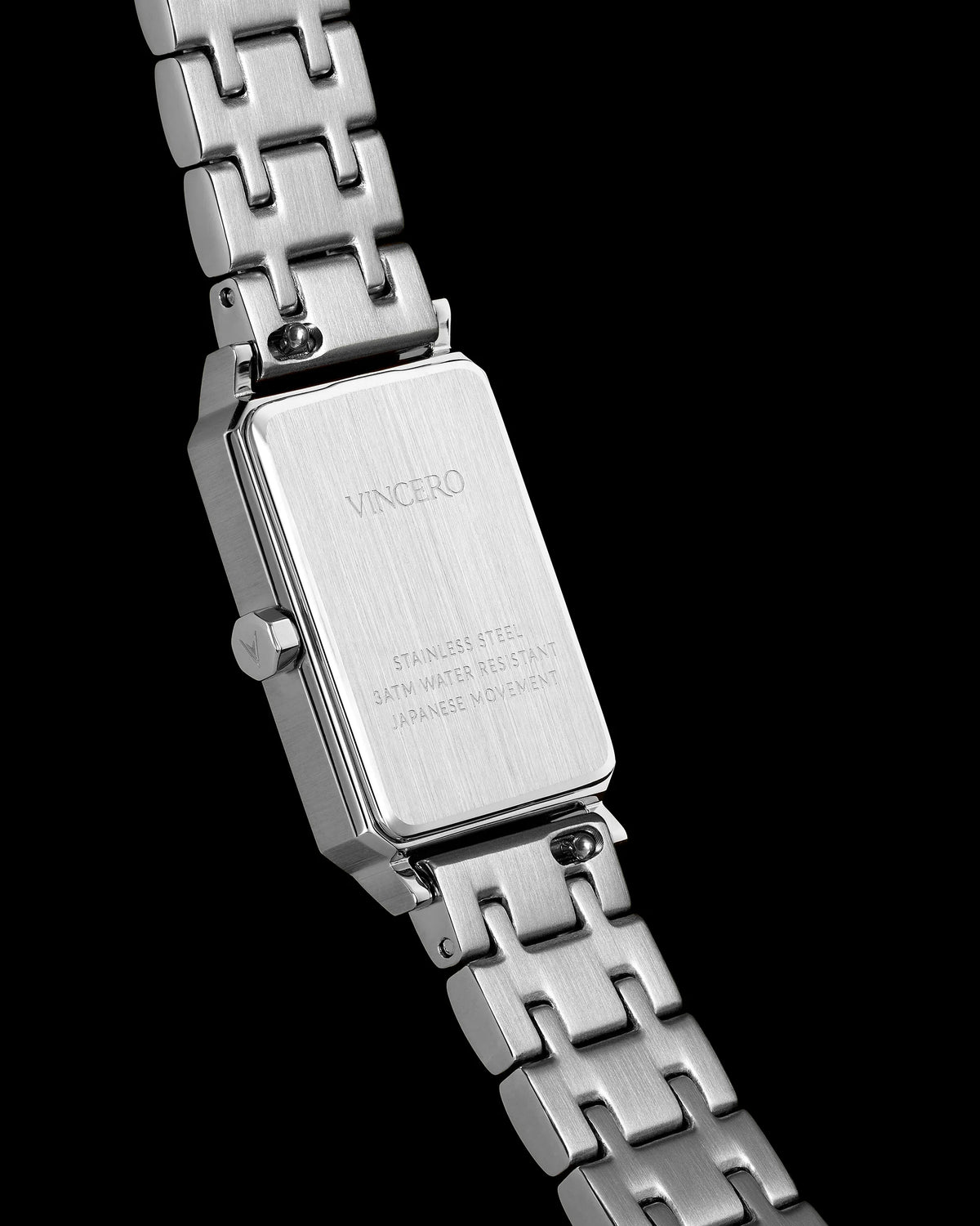 Close-up of a silver watch with 'Vancero' branding on a black background