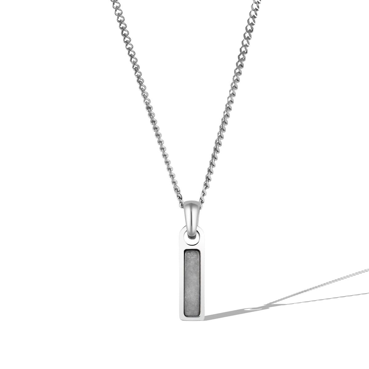 A silver necklace with a rectangular clear tag pendant attached to a chain.