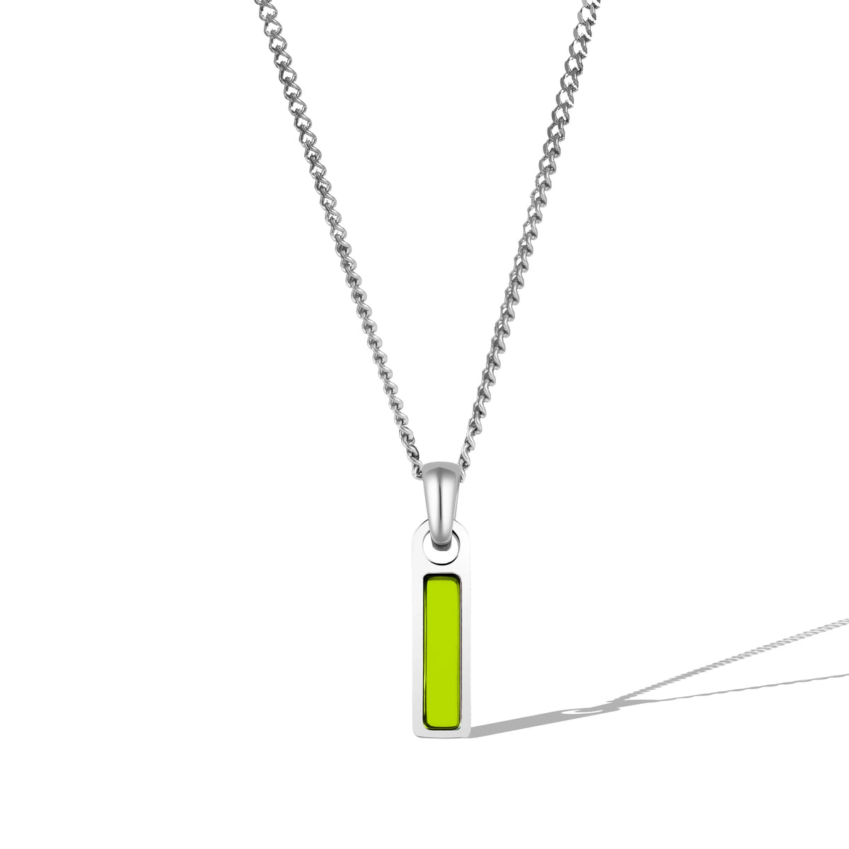 A silver necklace with a rectangular peridot tag pendant attached to a chain.