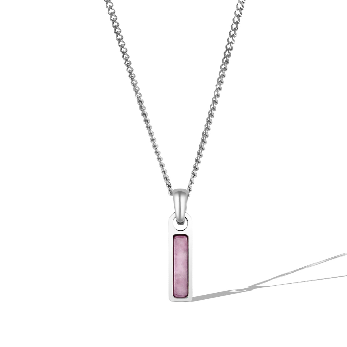 A silver necklace with a rectangular red tag pendant attached to a chain.