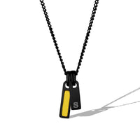 Black and yellow pendant necklace on a white background