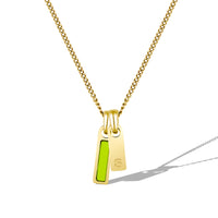 Gold necklace with a pendant featuring a green stone on a white background
