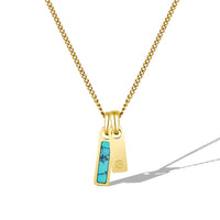 Gold necklace with a turquoise pendant on a white background